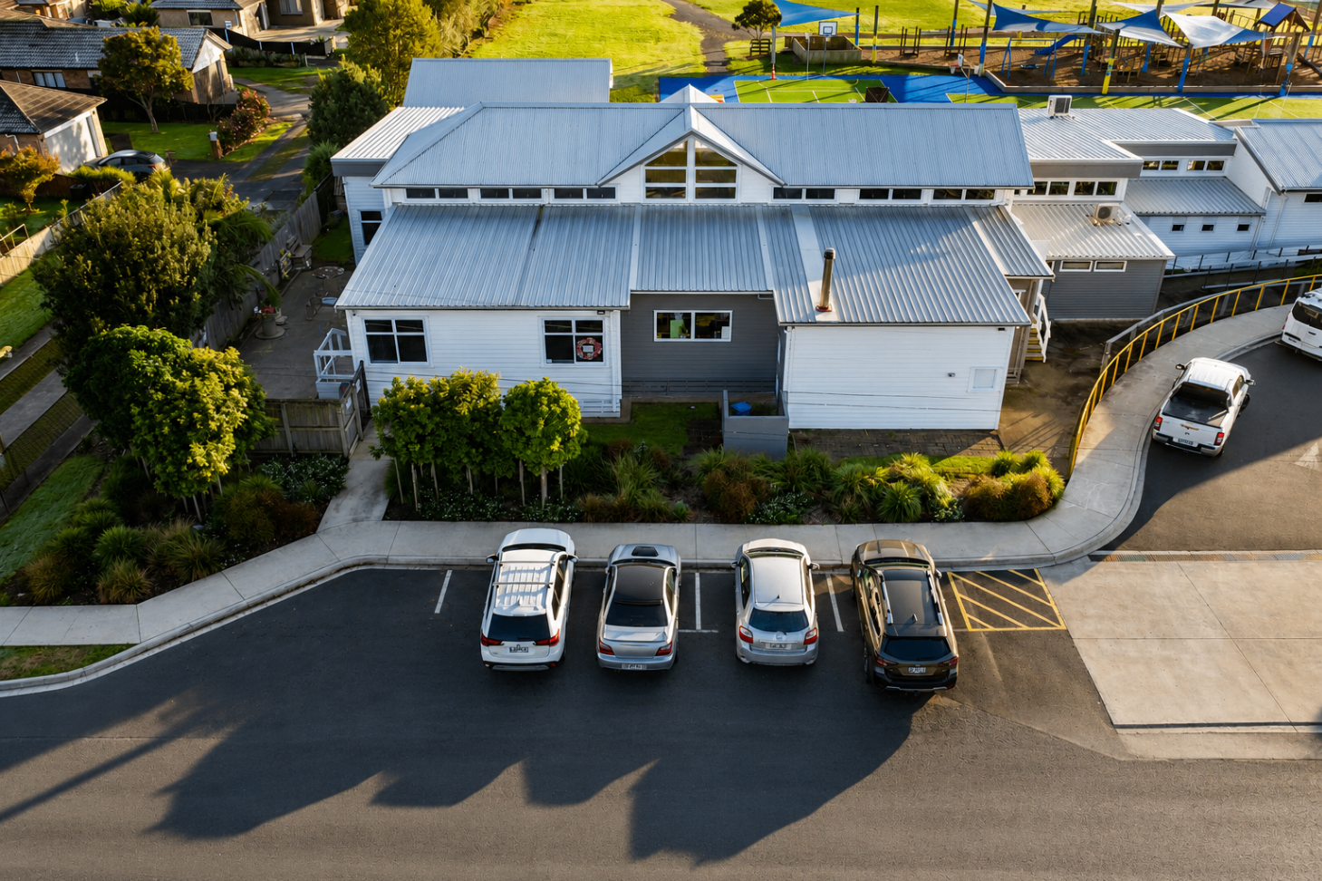 Aerial view of Parakai School building edge landscaping and parking