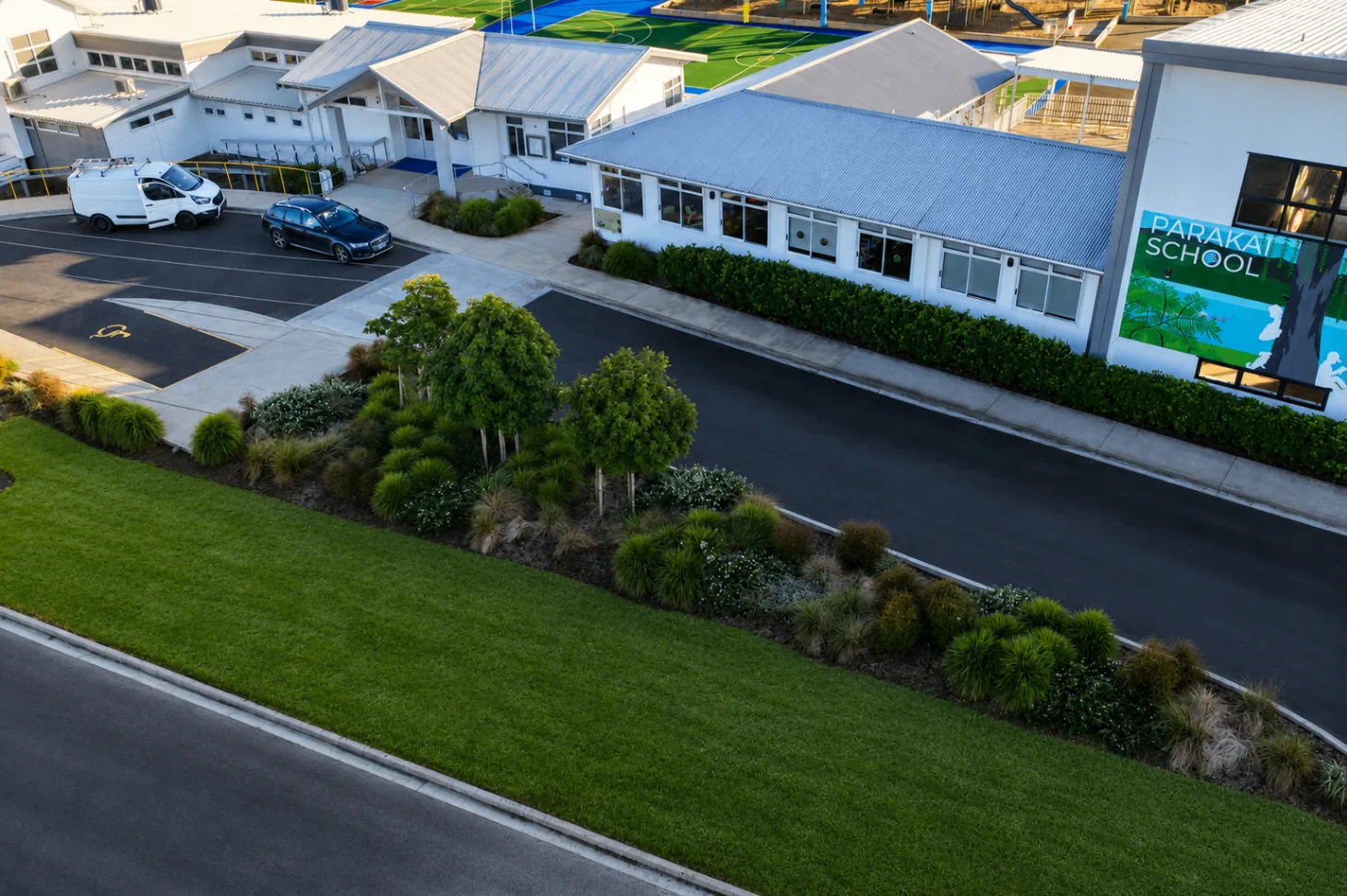 Parakai School campus frontage with structured planting and lawn