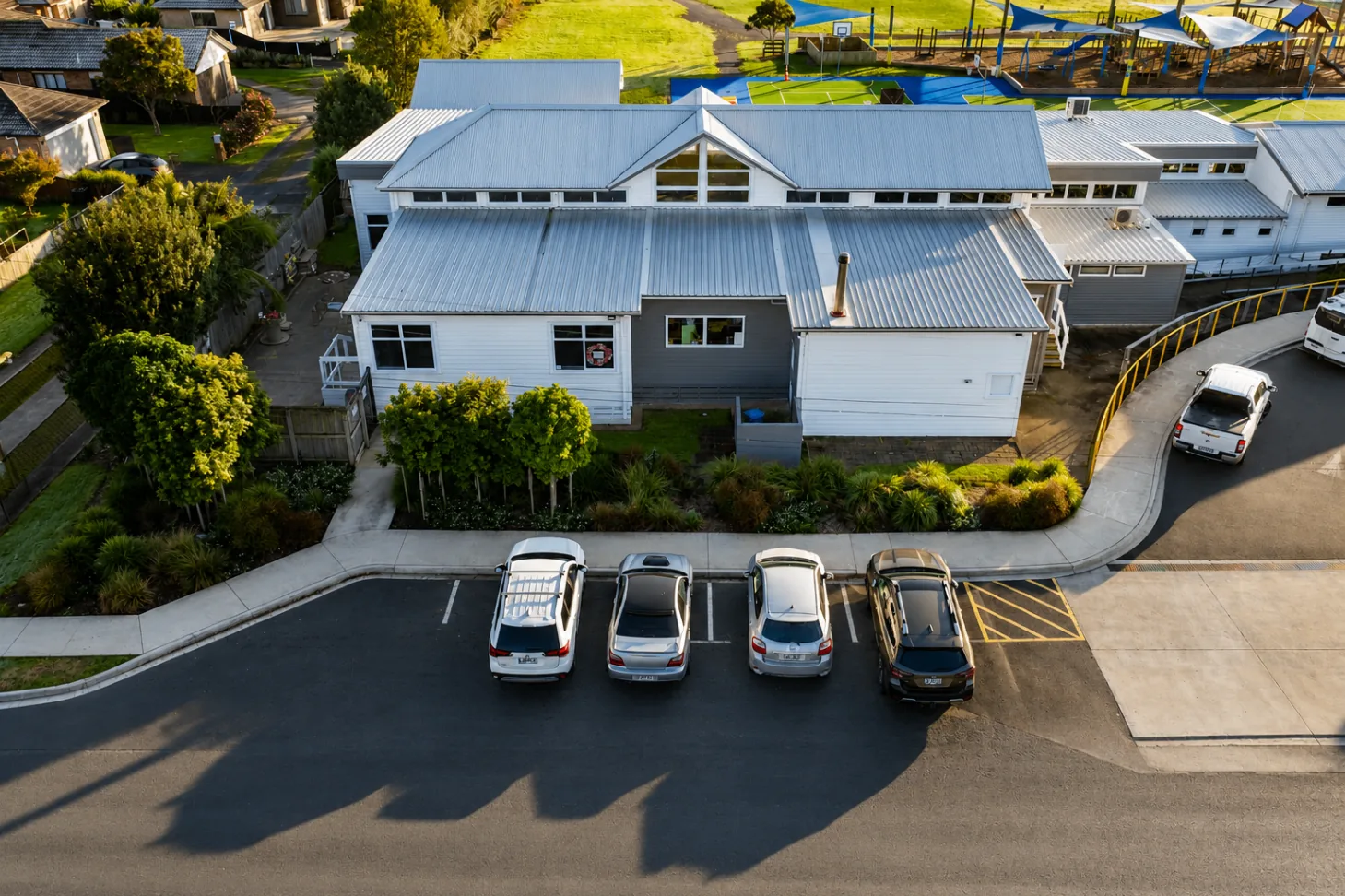 Aerial view of Parakai School building edge landscaping and parking